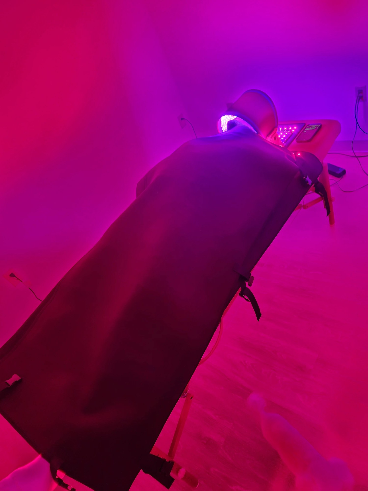 Real full body infrared light therapy session with red light glow at Evolve EMS Therapy in Greenville, SC